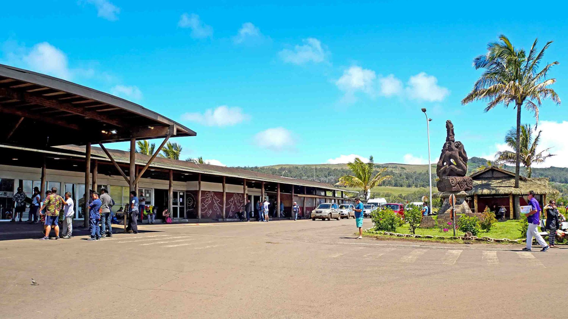 People walk toward a small passenger terminal.