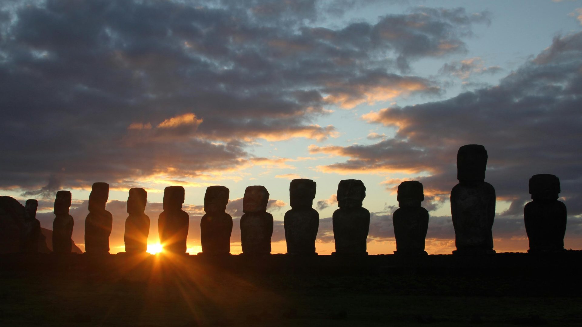 Sunrise behind 15 giant statues.