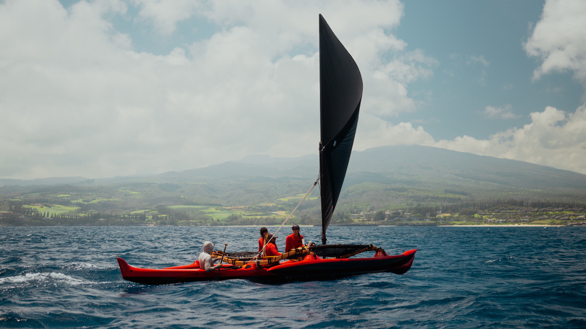 Traditional canoe with sails up.
