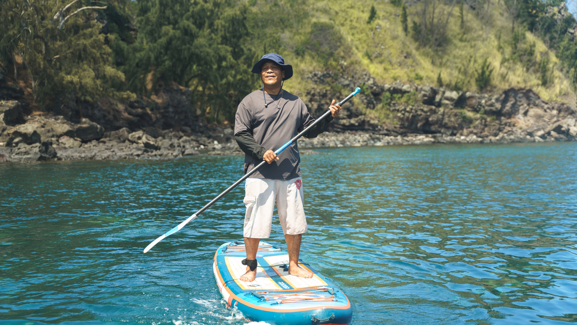 Man on stand up paddle board.