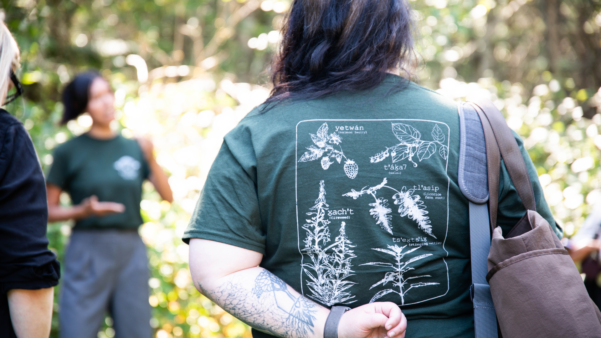 Green t-shirt with illustrations of native plants