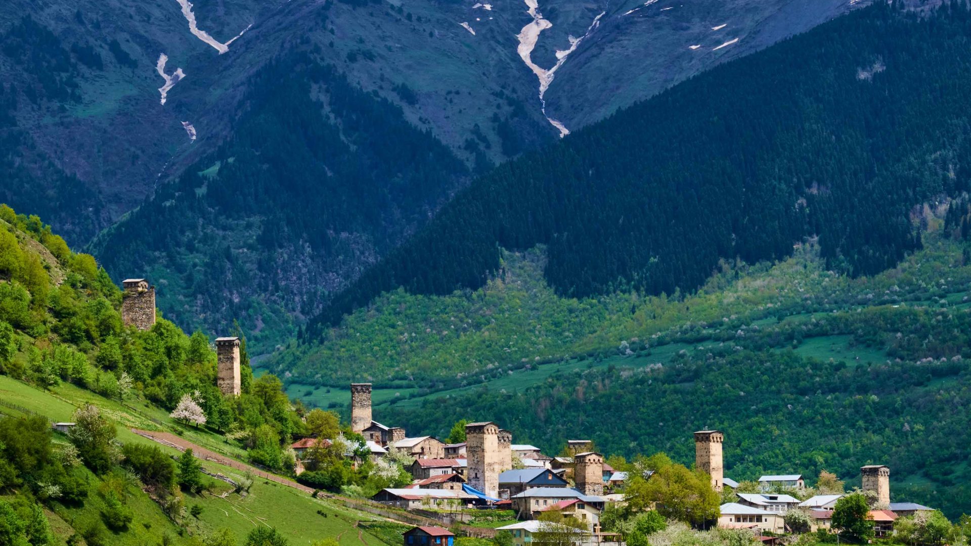 Towers in a small town located in green mountains.