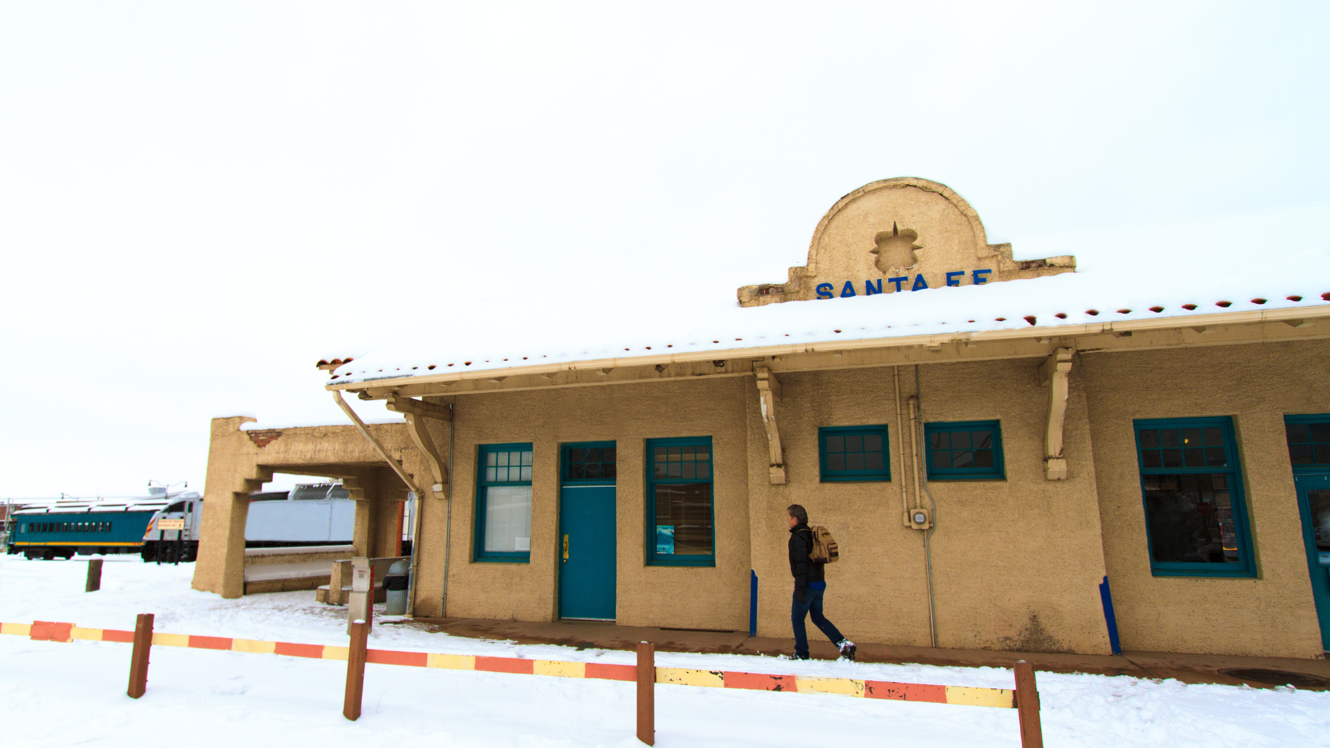 Snow on tan building