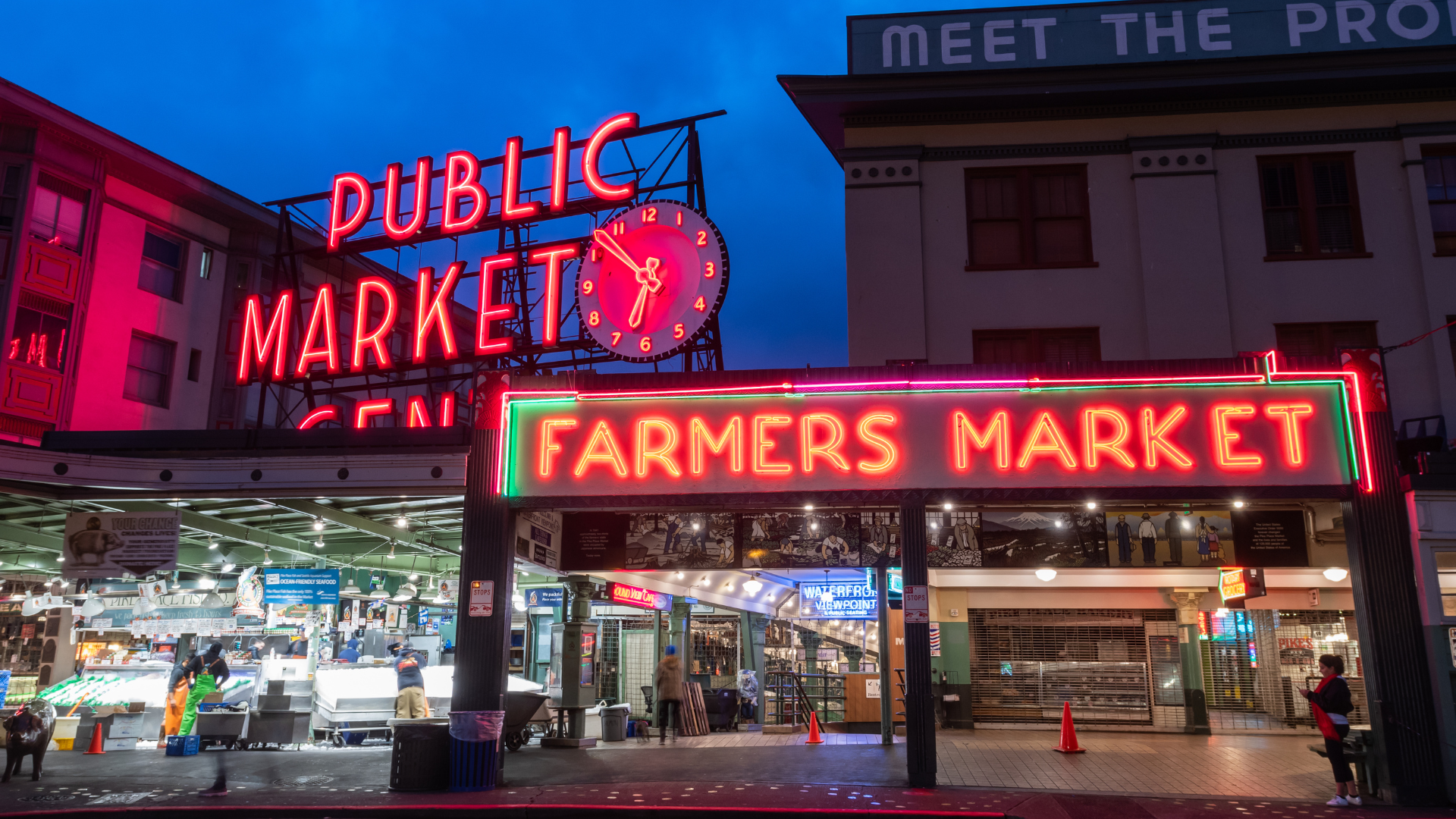 Neon signs reading 'Public Market' and 'Farmers Market'
