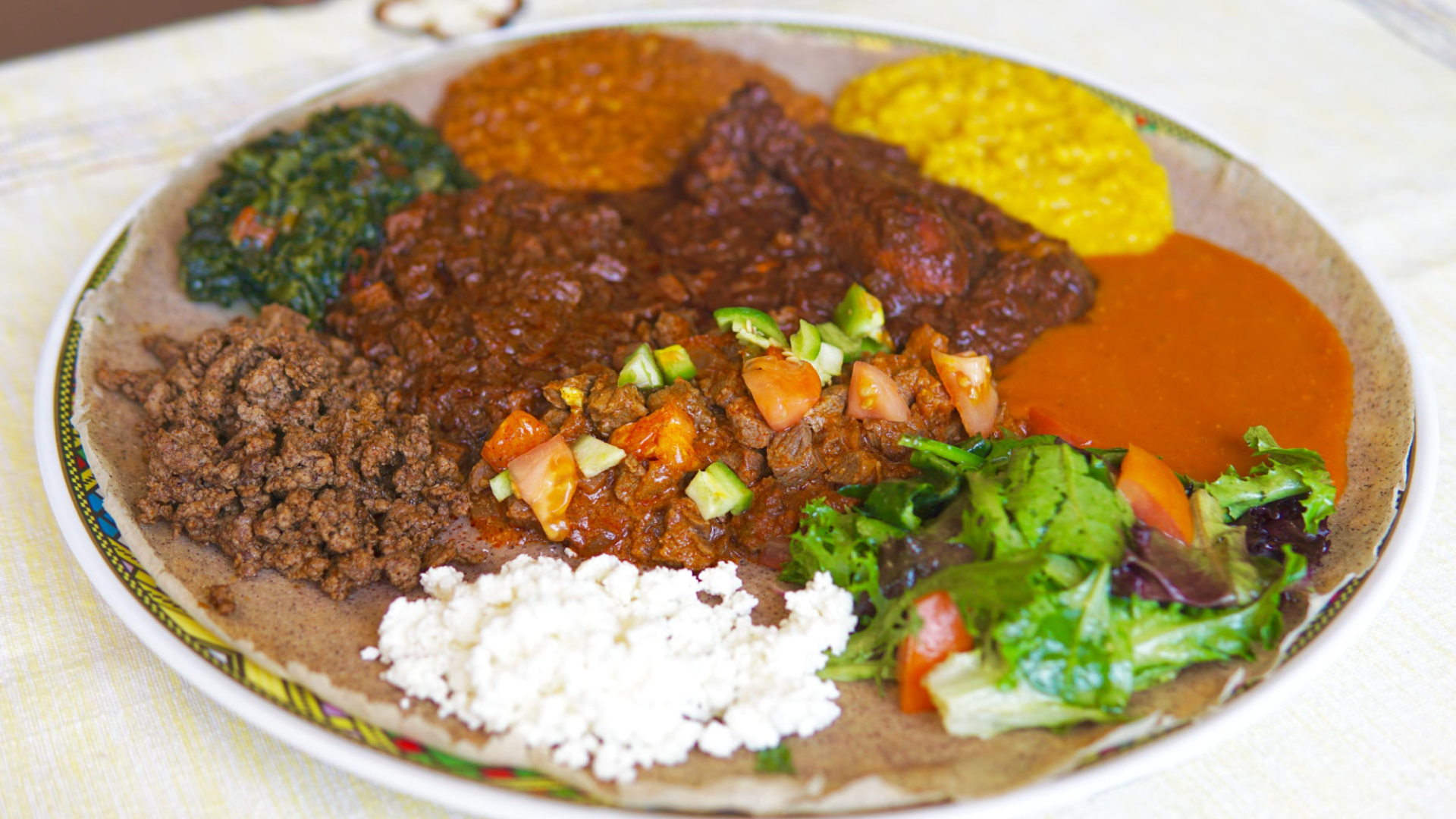 Mix of brown, green and yellow stews on brown flat bread