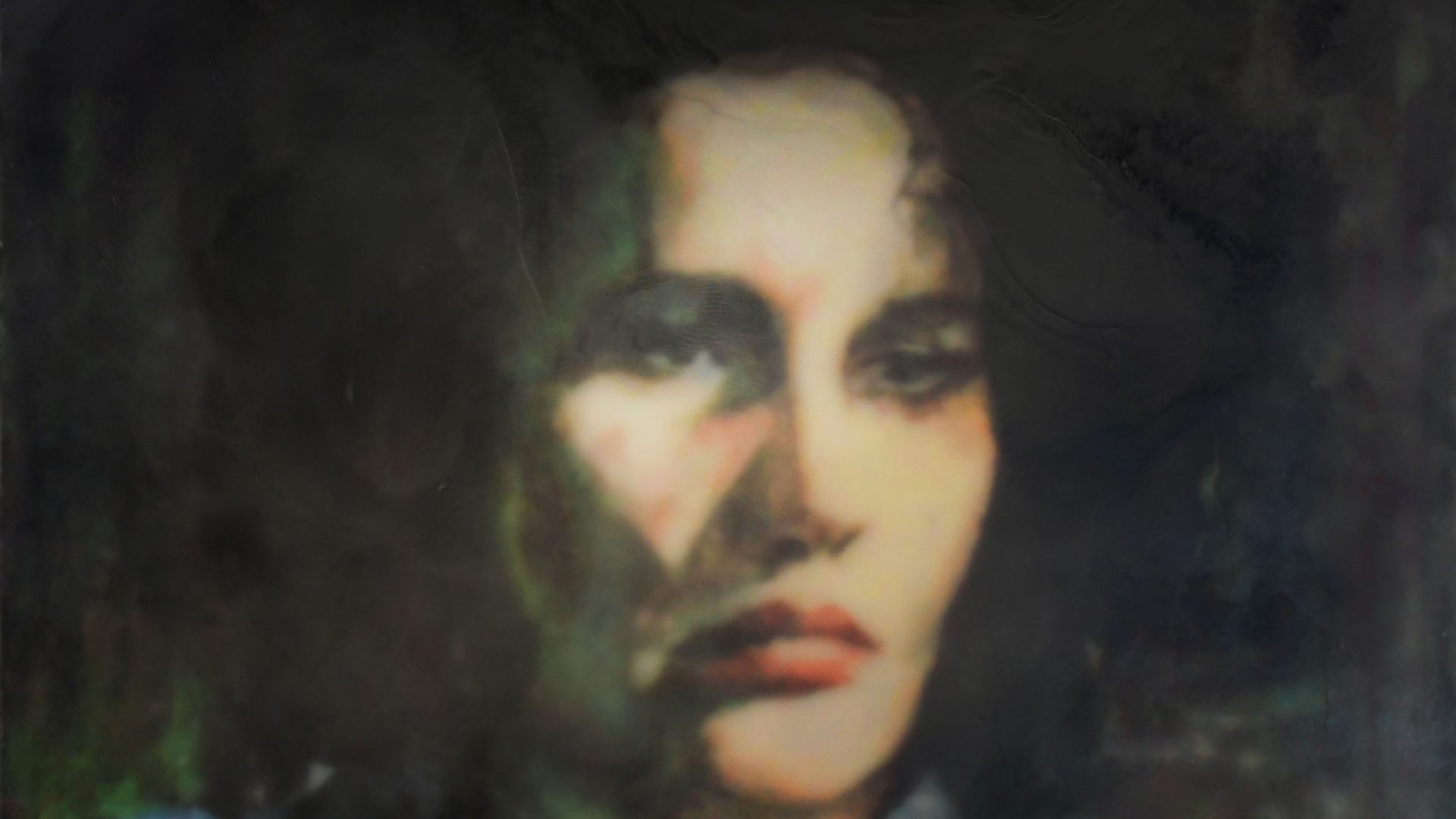 A portrait of a woman with long dark hair.