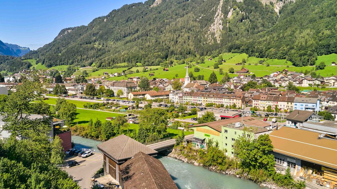A town sits below green hills.