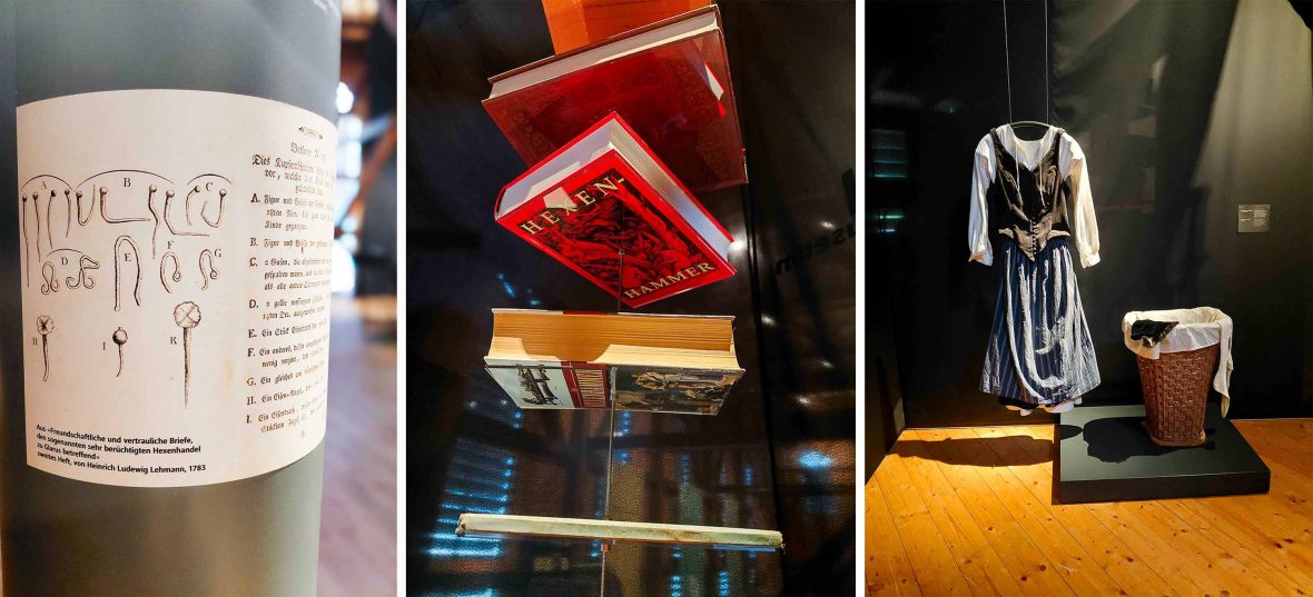 Items on display at a museum. Left: A document with illustrations of pins and needles. Middle: Copies of a red book. Right: Items of clothing in a glass display unit.